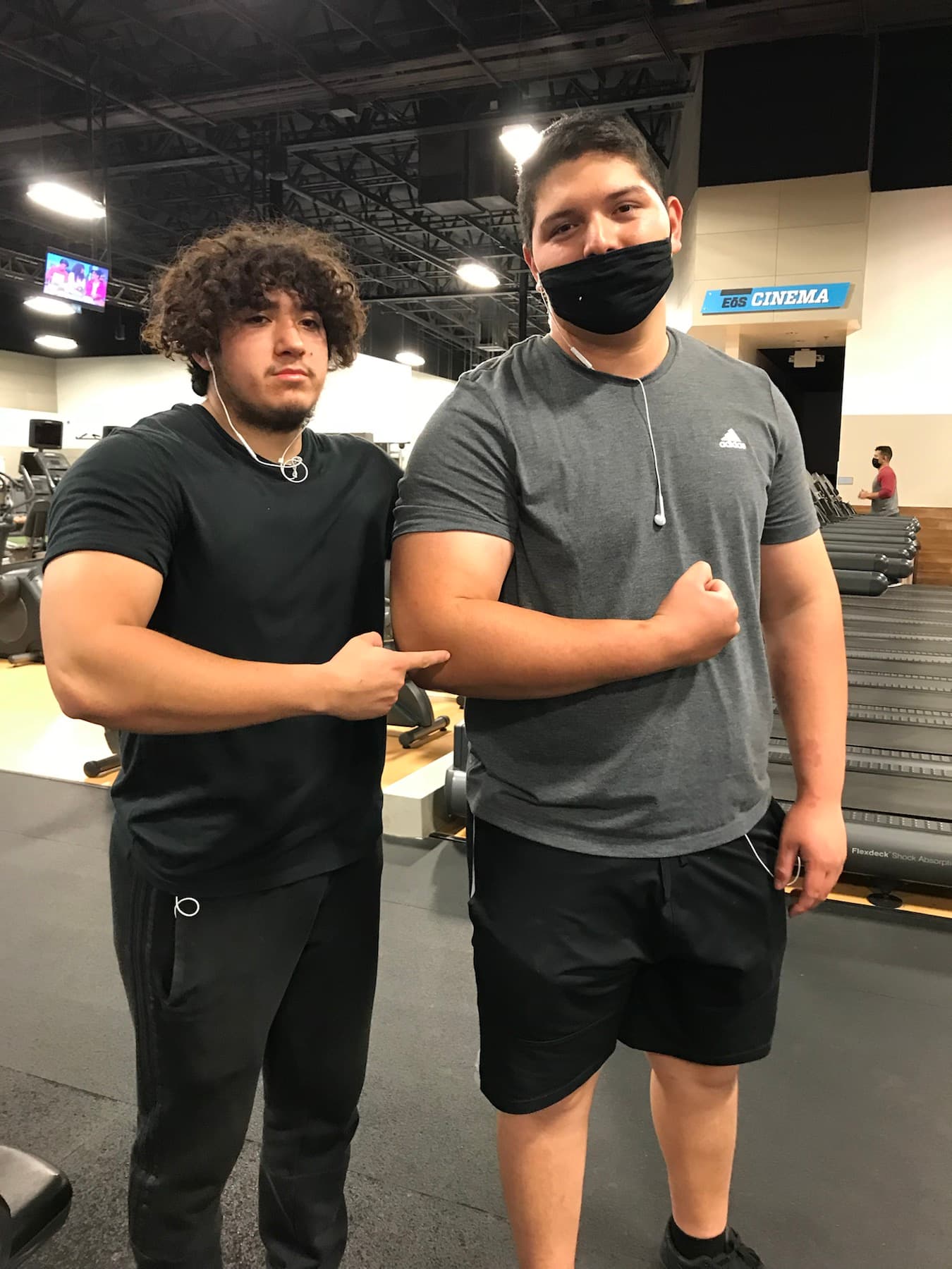 Brian and a friend standing in a gym