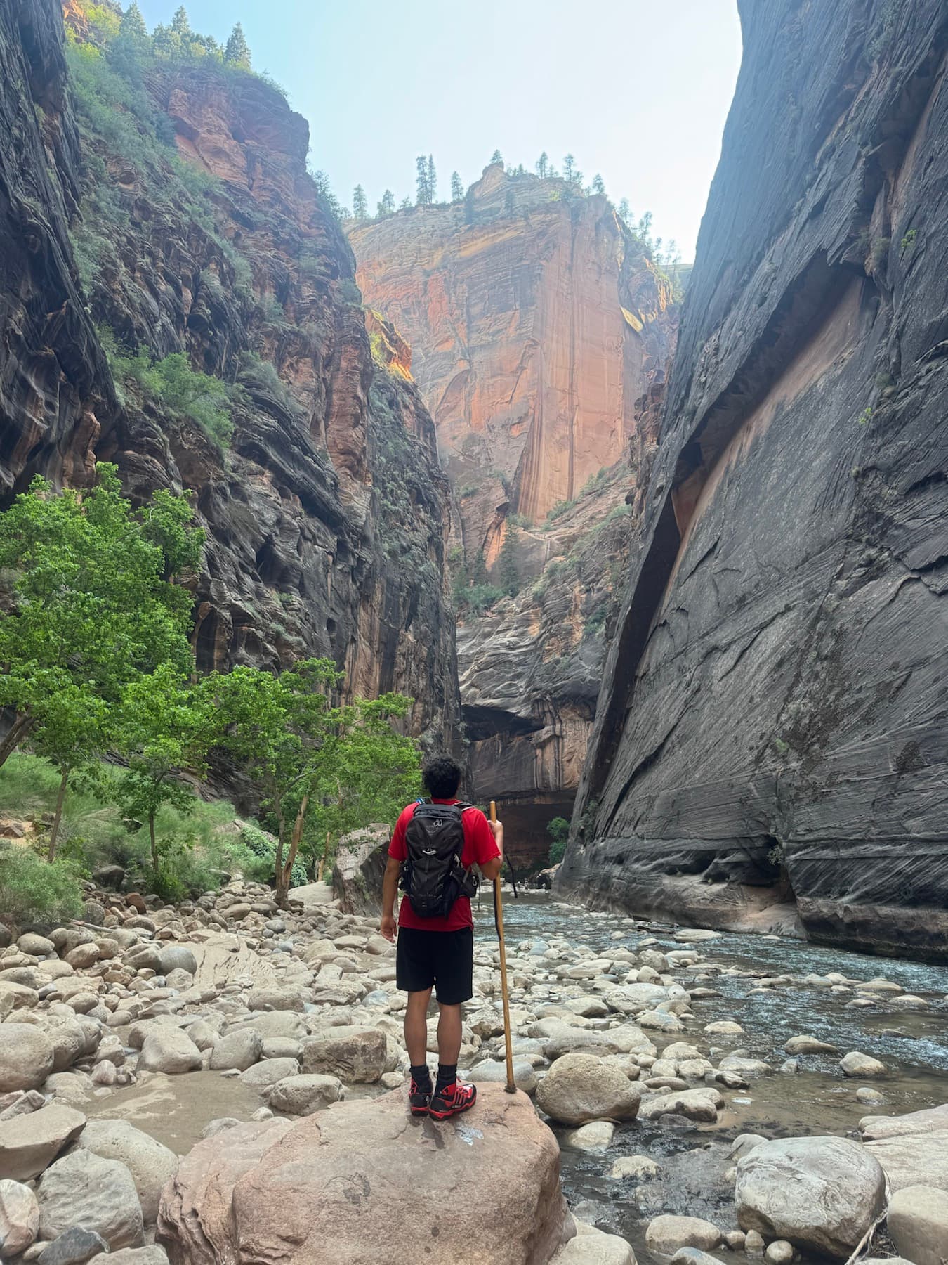 Brian standing in a canyon with tall rock walls